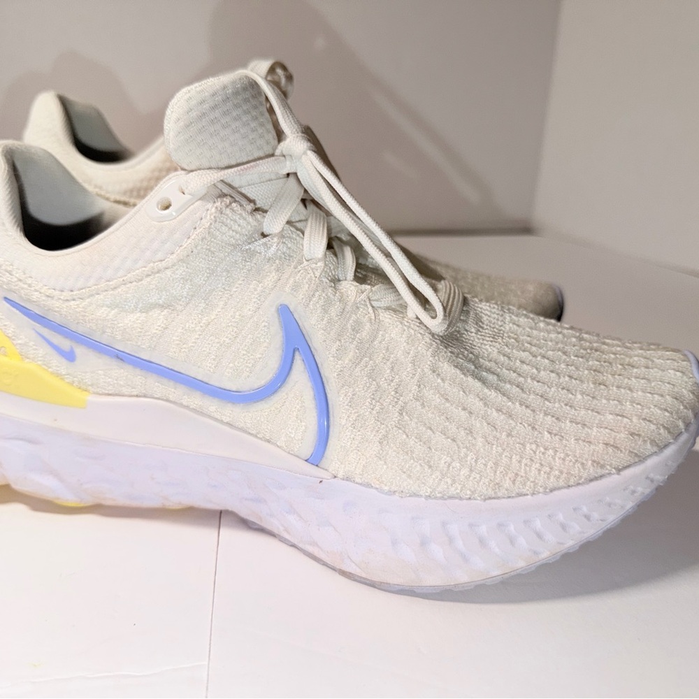 Nike Women's White Sneakers with Light Blue Swoosh and Yellow Accent
